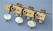 L201: Baker style engraved brass side plates, light mop oval buttons, cream colored rollers